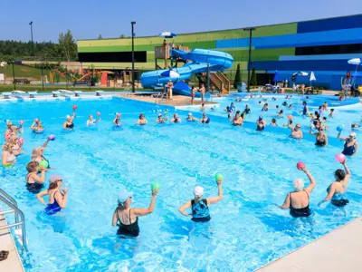 Group of women doing exercises in pool.