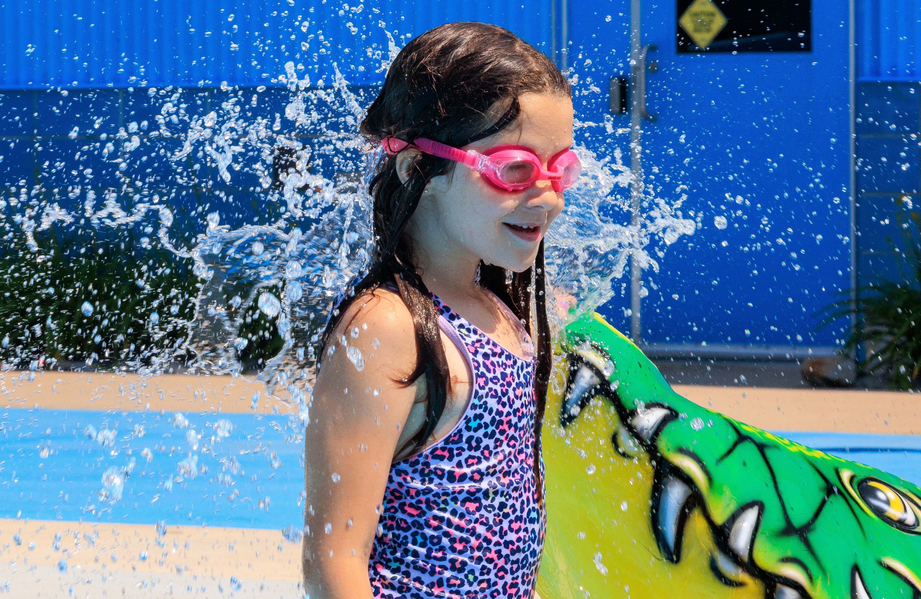Water spraying on a young girls face.